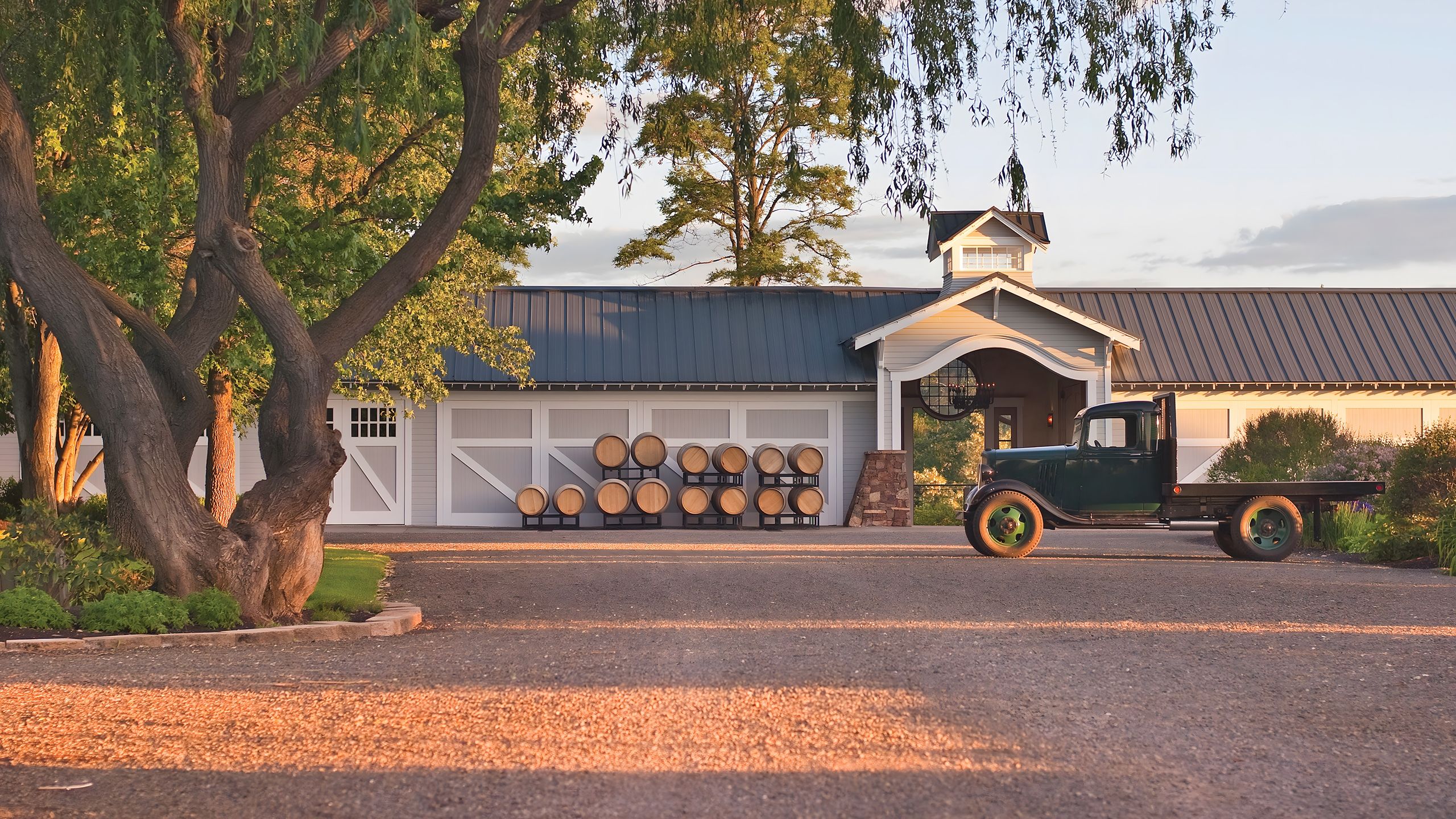 Circle driveway at Abeja with a vintage farm truck parked in front of the farmhouse