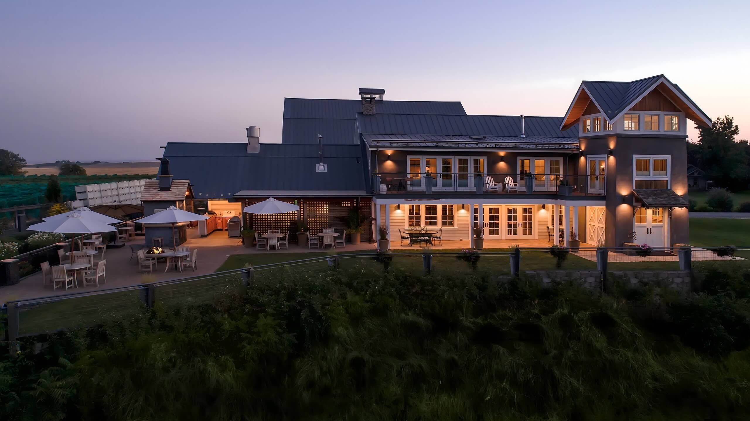 The Abeja estate illuminated at night against a dark sky