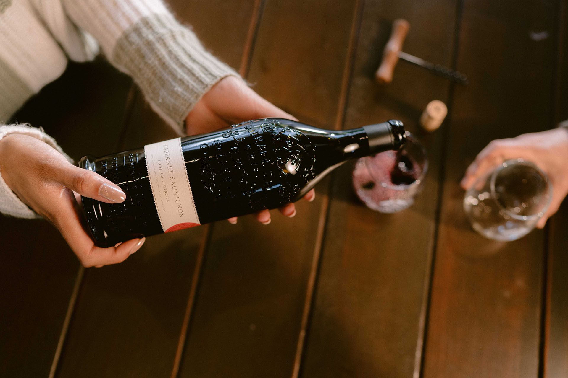 Deep purple Cabernet Sauvignon clusters hanging from the vine