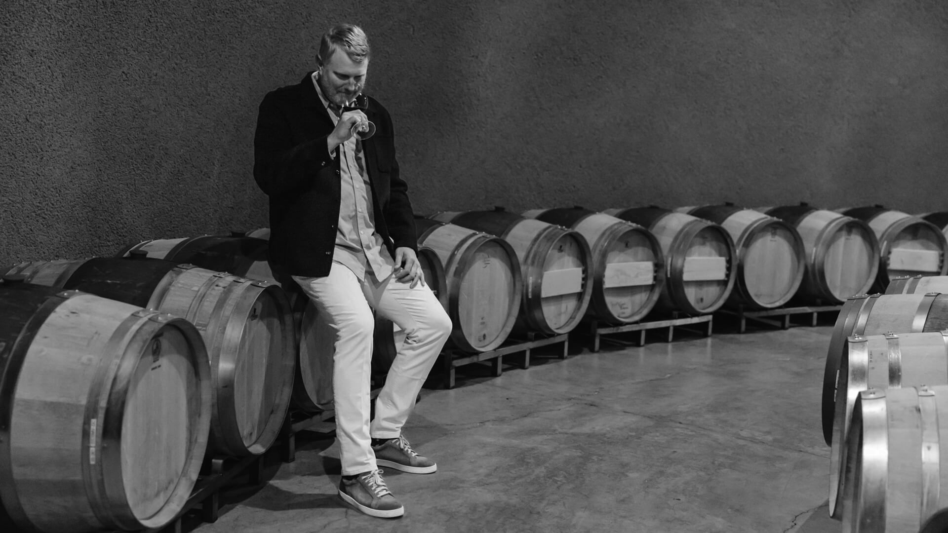 Winemaker Shawn Johnson tasting wine in the barrel room at Amulet Estate